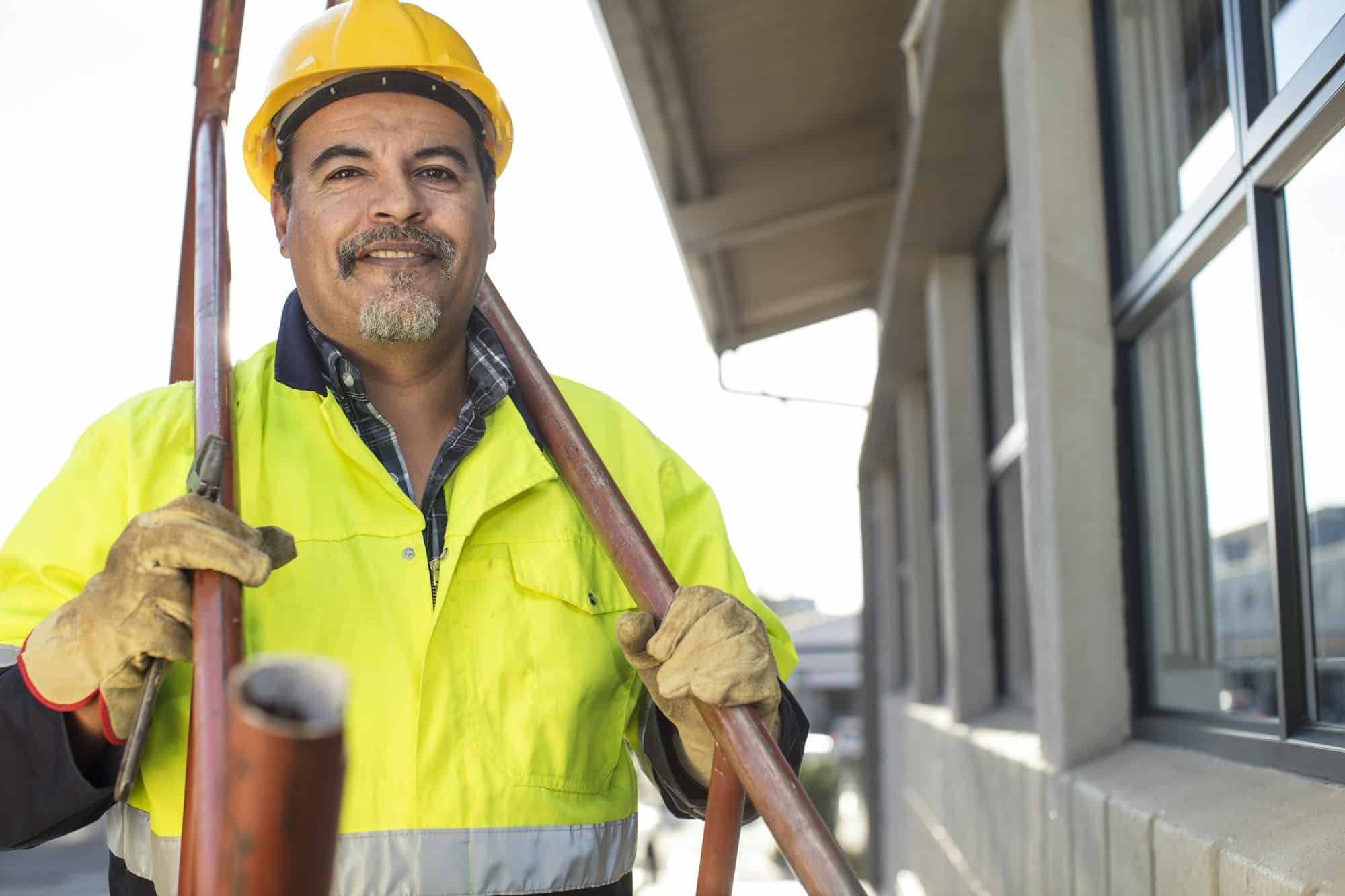 South Africa, Cape Town, Builder holding pipes